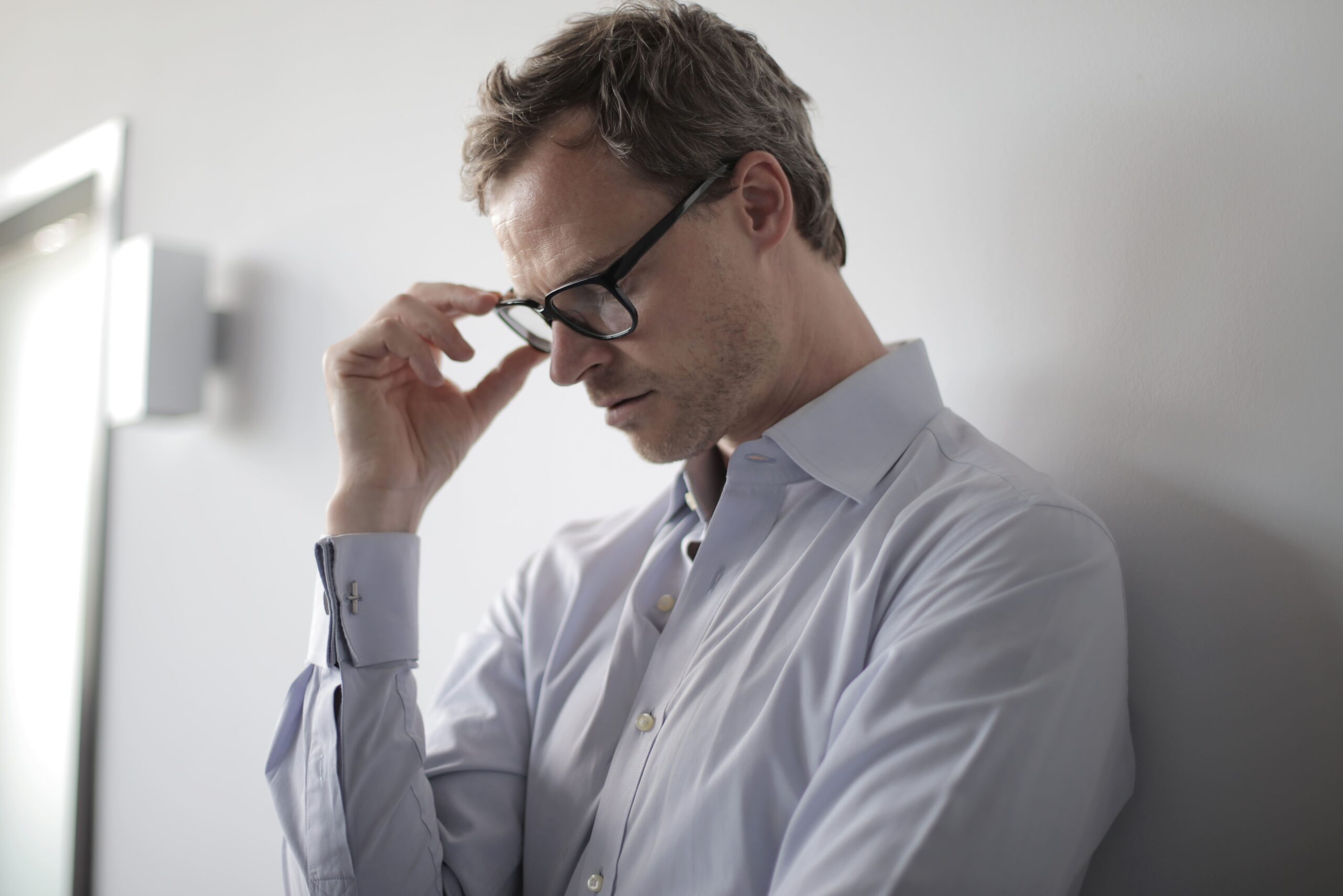 Image of man with glasses looking worried.